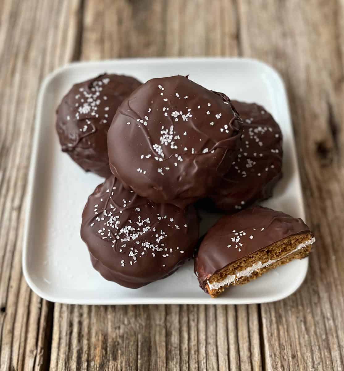 White plate with cookies on a wood counter