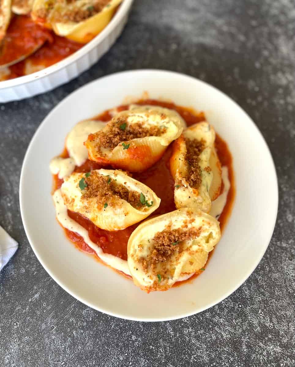 Large stuffed pasta shells in a white bowl