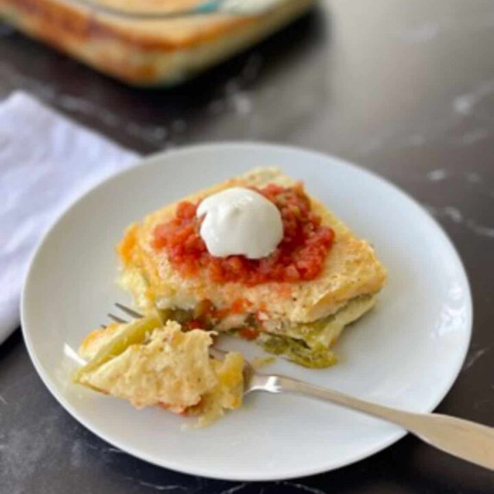 Chili Relleno casserole on a white plate. There is a fork on the plate