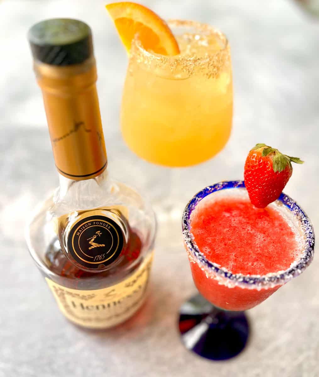 Two cocktails and a bottle of Hennessy