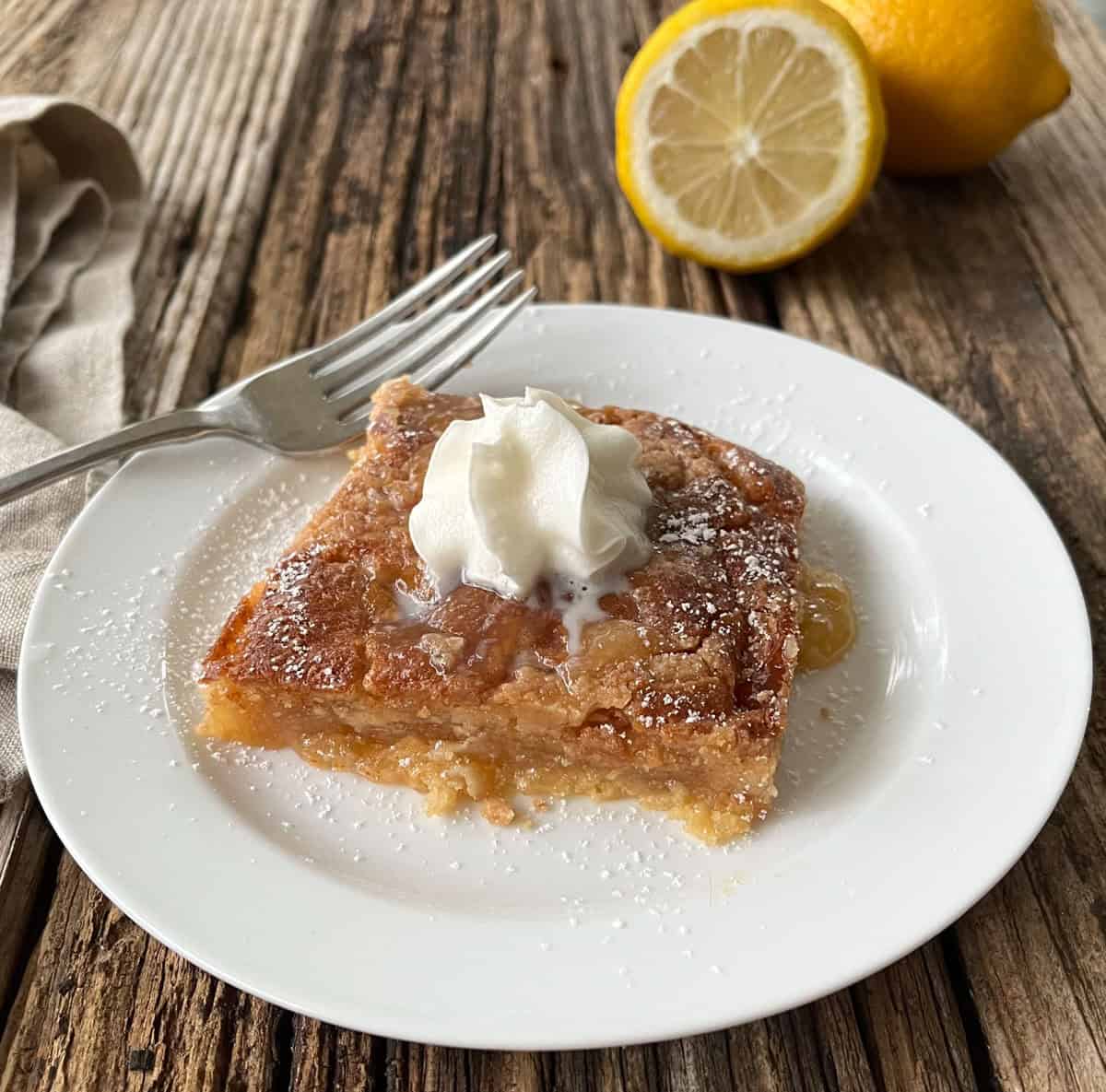 Piece of cake on a white plate with a fork
