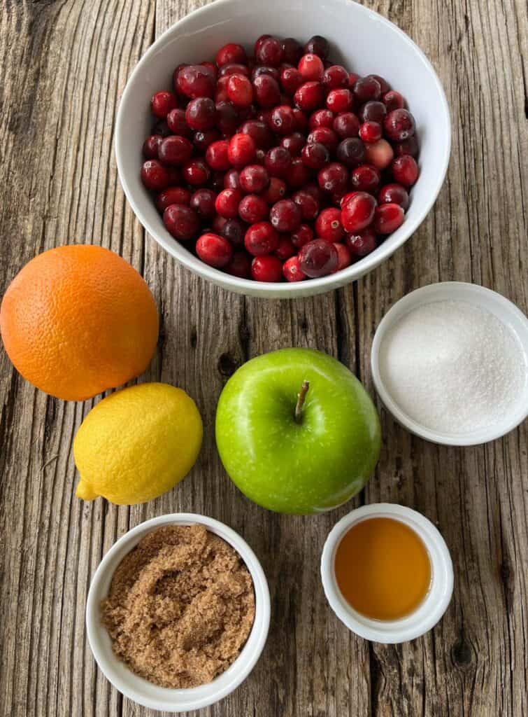 Ingredients for cranberry sauce on a wooden table