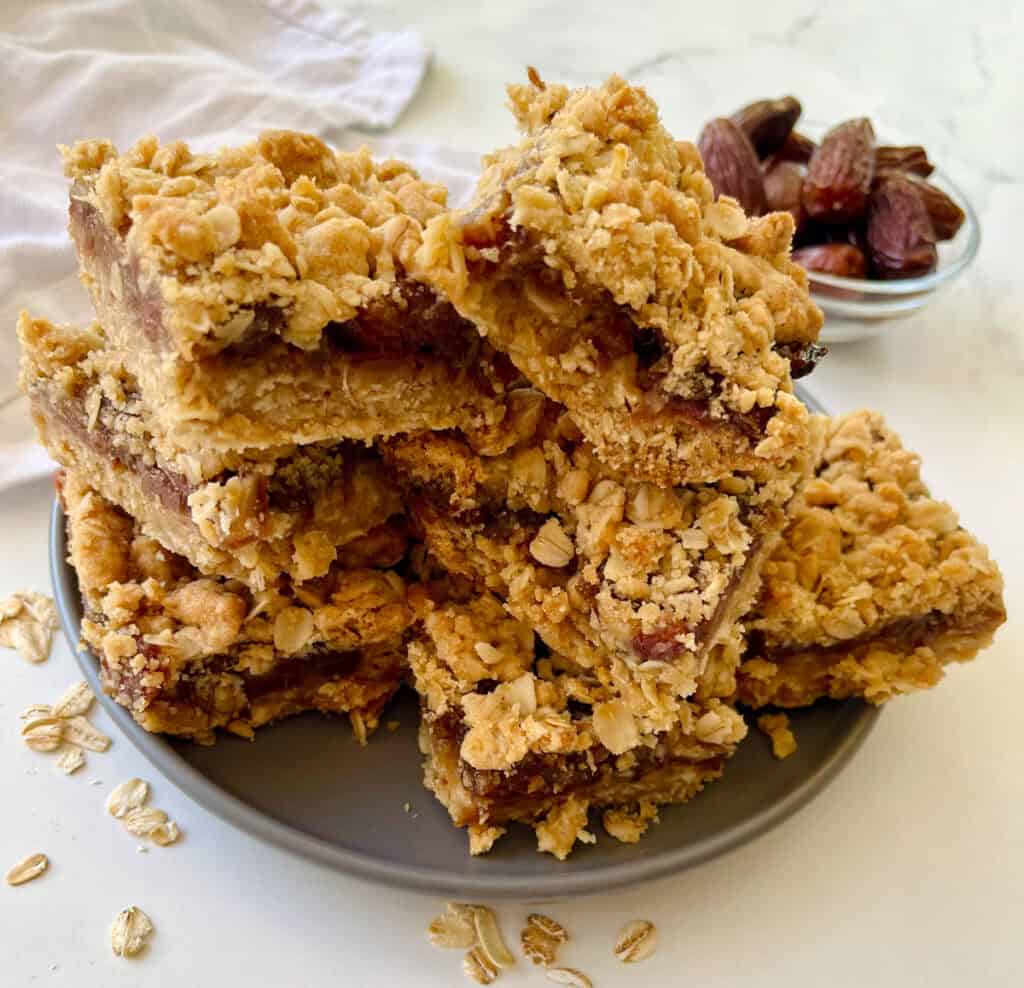A plate of oatmeal bars with dates.