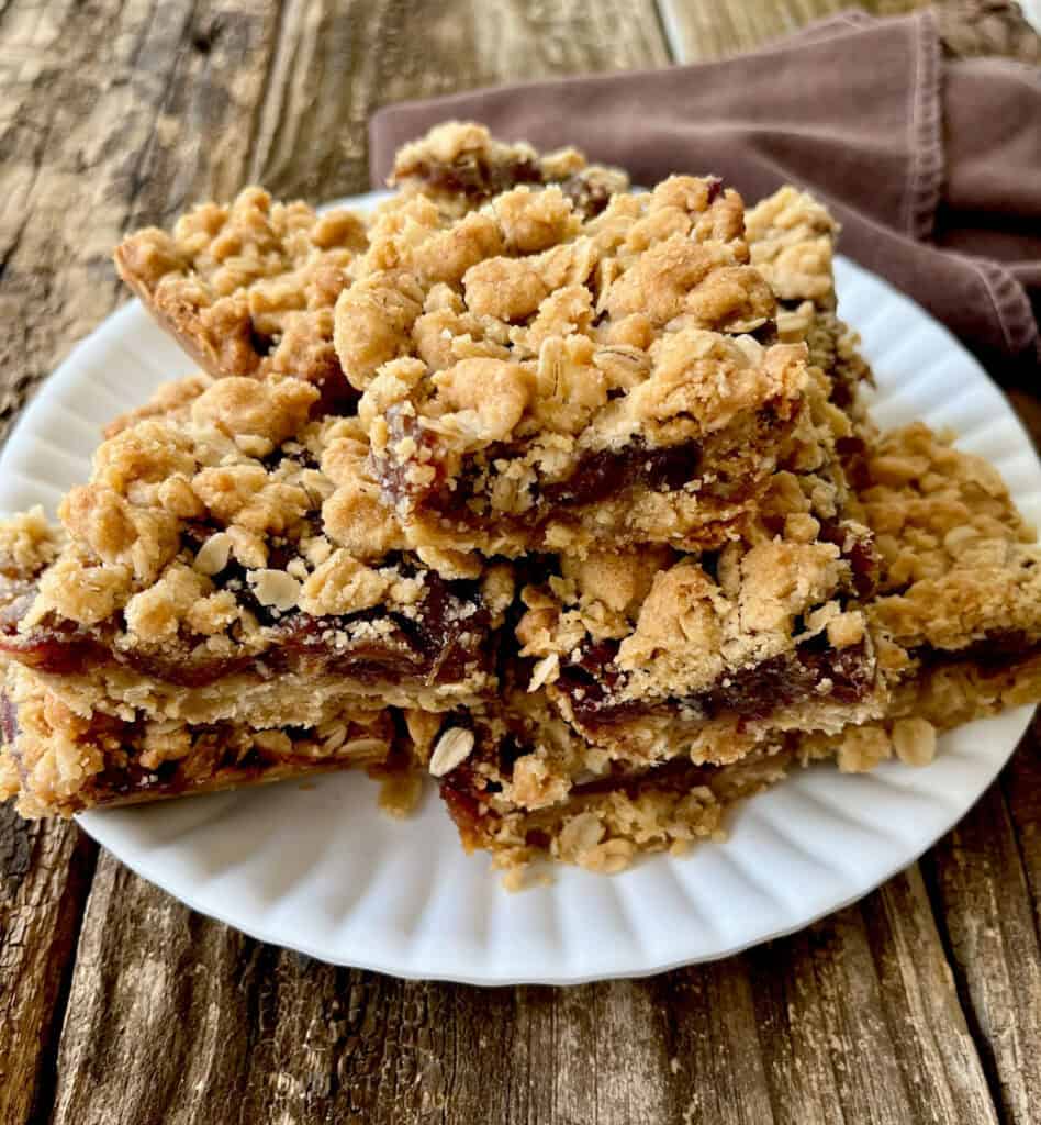 A plate of oatmeal bars on a wooden table.
