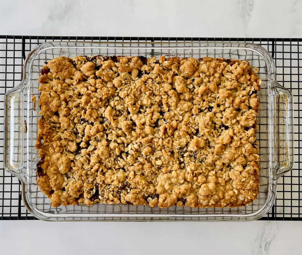 A square baking dish filled with oatmeal and dates.