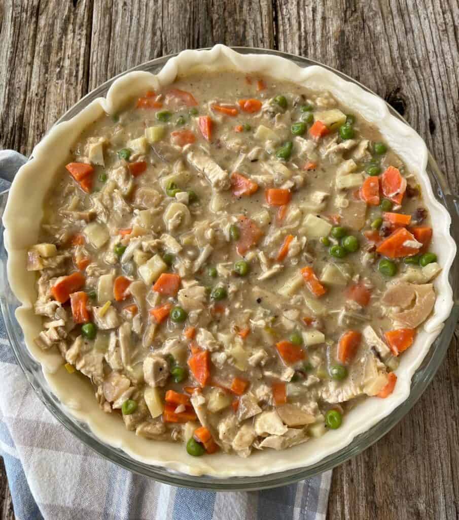 A pie crust filled with turkey and vegetables.