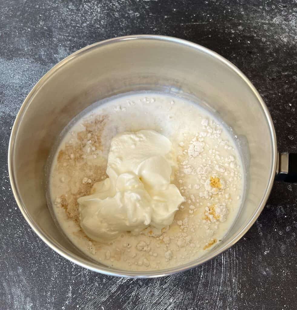 A metal pan with sour cream and other ingredients.