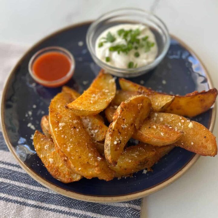 Baked potato wedges with sour cream and chives.