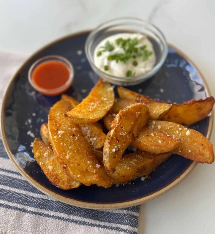 Baked potato wedges with sour cream and chives.