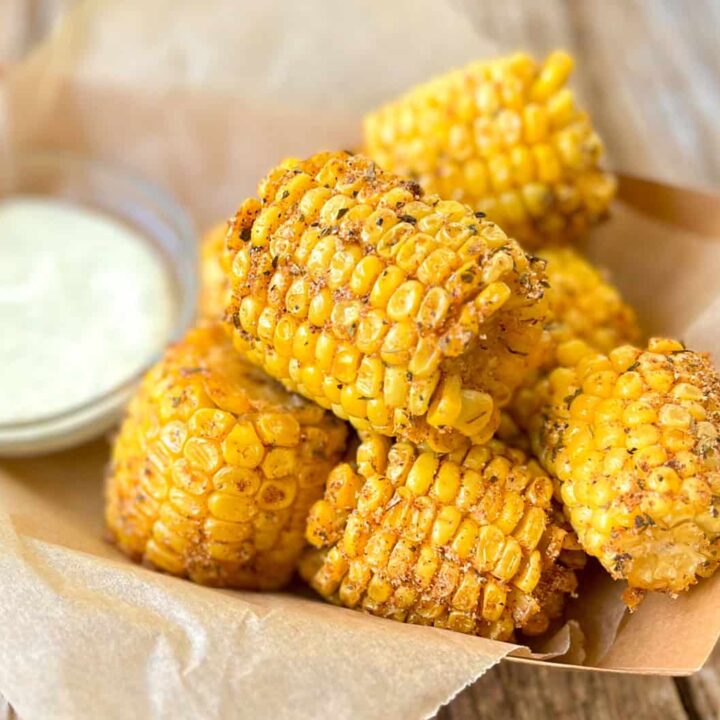 Fried corn on the cob with ranch dressing.