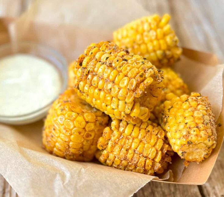 Fried corn on the cob with ranch dressing.