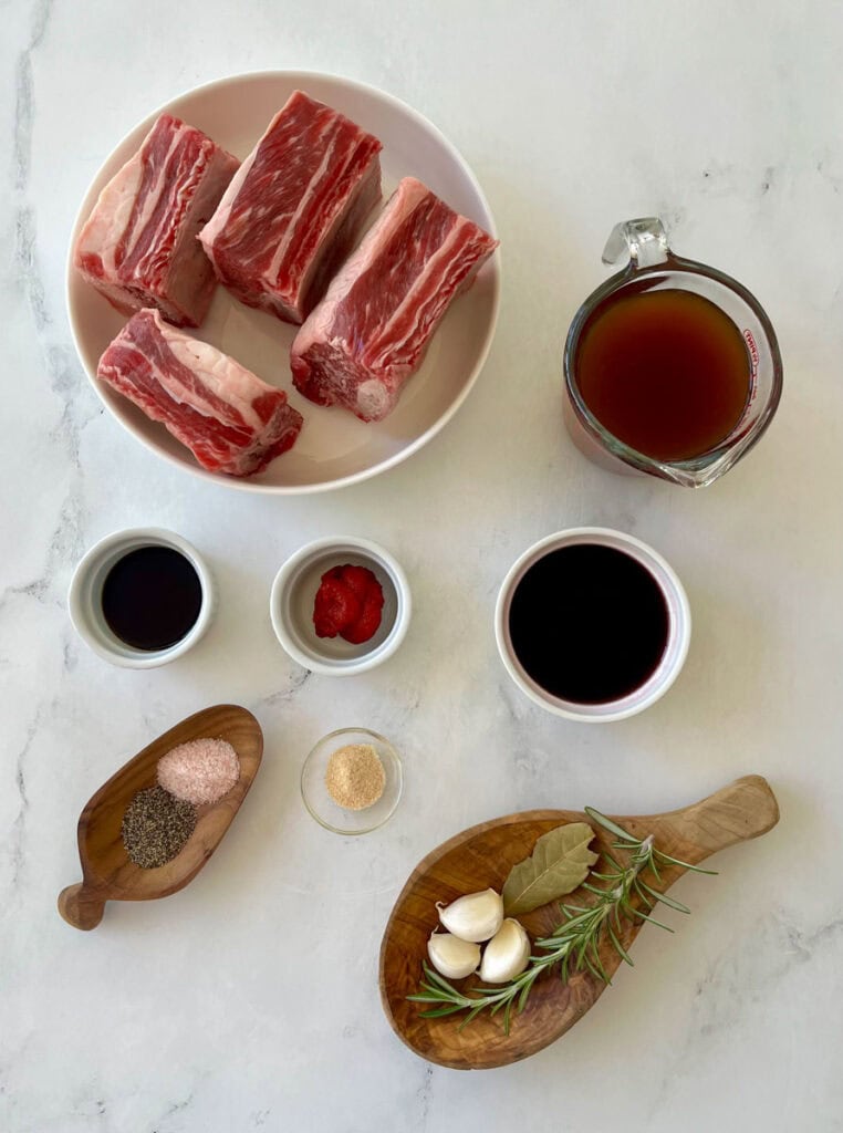 Ingredients for Short Ribs on a marble counter.