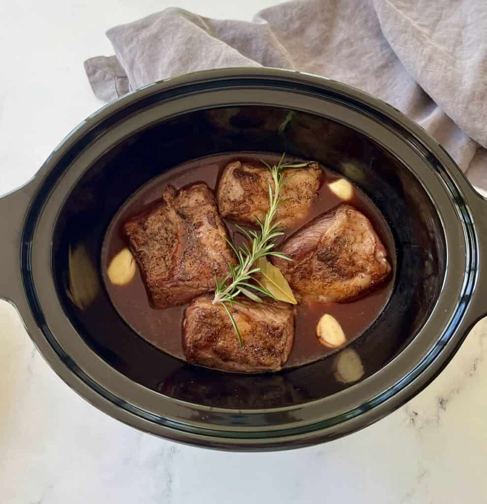 Slow cooker beef short ribs with rosemary and garlic.