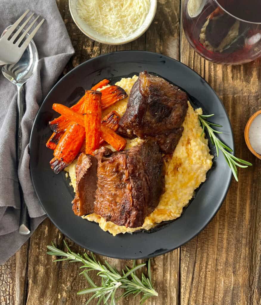 Short Ribs and polenta on a plate.