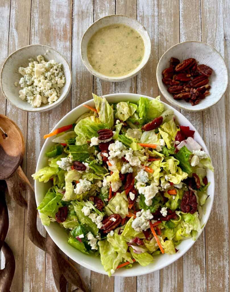 A salad with lettuce, carrots, and other ingredients in bowls.