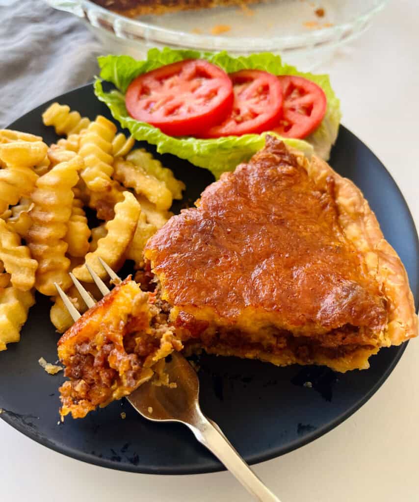 Cheeseburger pie with side dishes.
