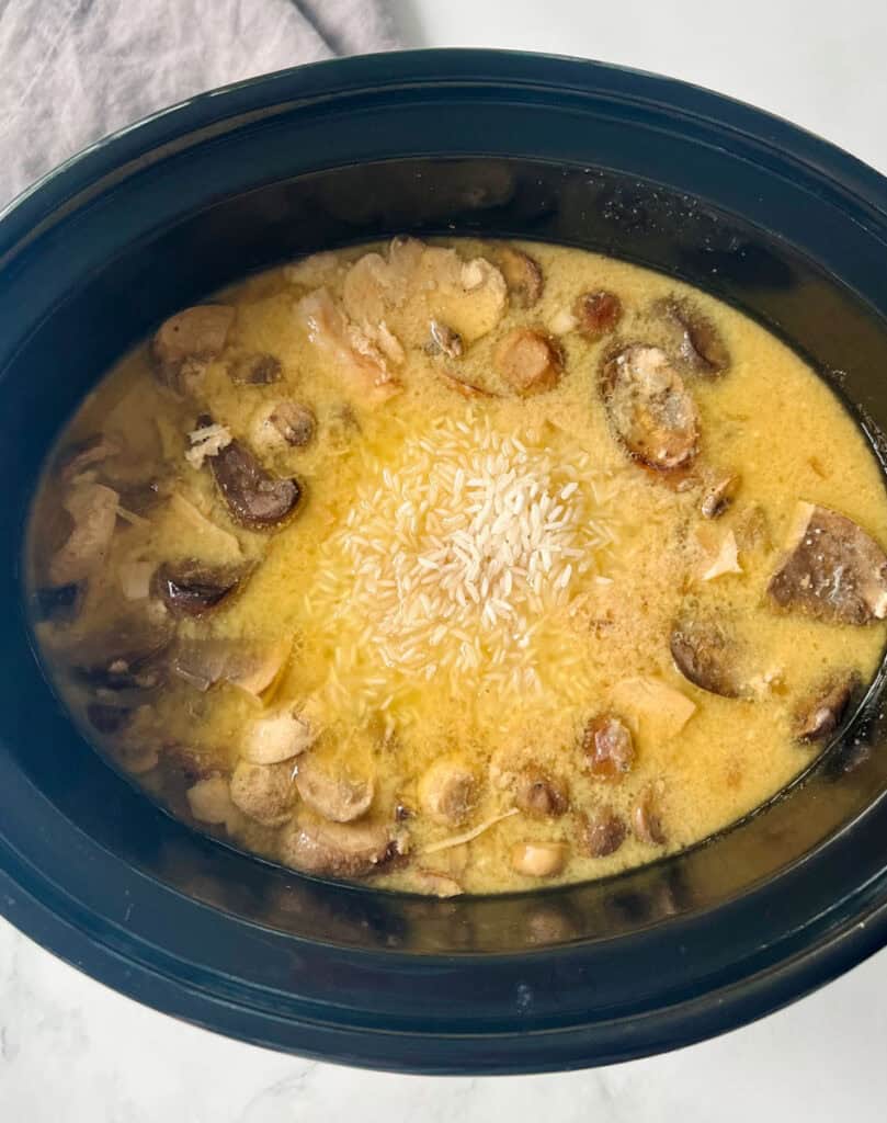 Slow cooker pork chops, mushrooms, mushroom soup, seasonings, and rice.