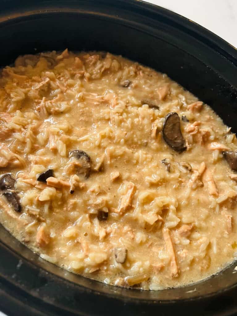 Slow cooker with shredded pork chops, mushroom soup, and rice.