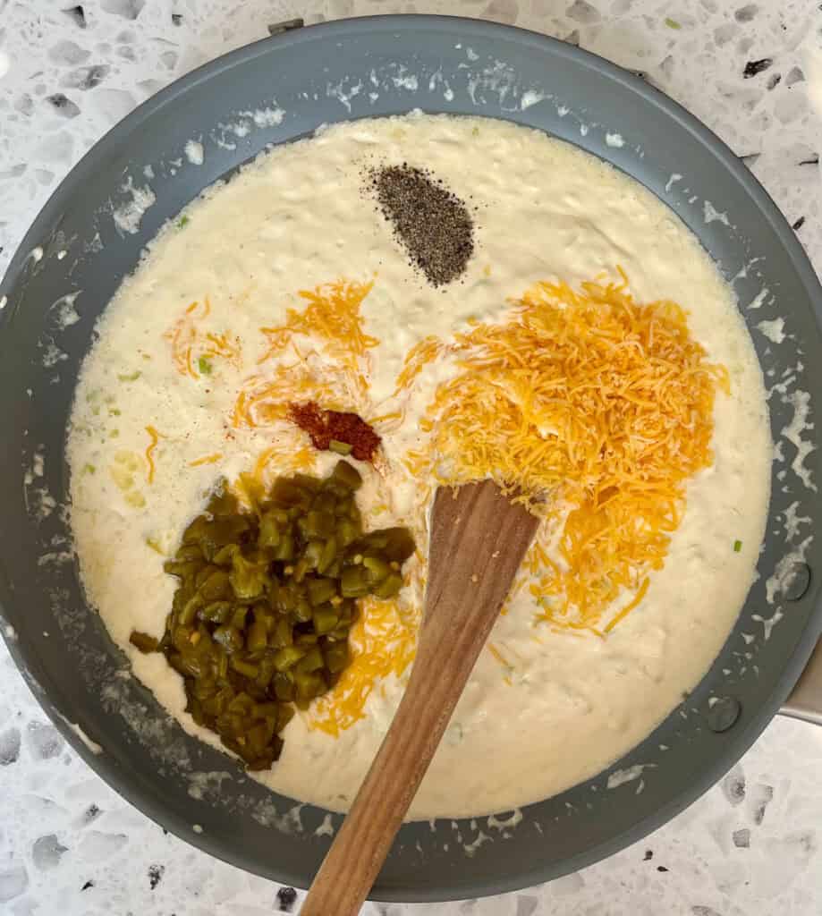 The ingredients for corn casserole in a skillet.