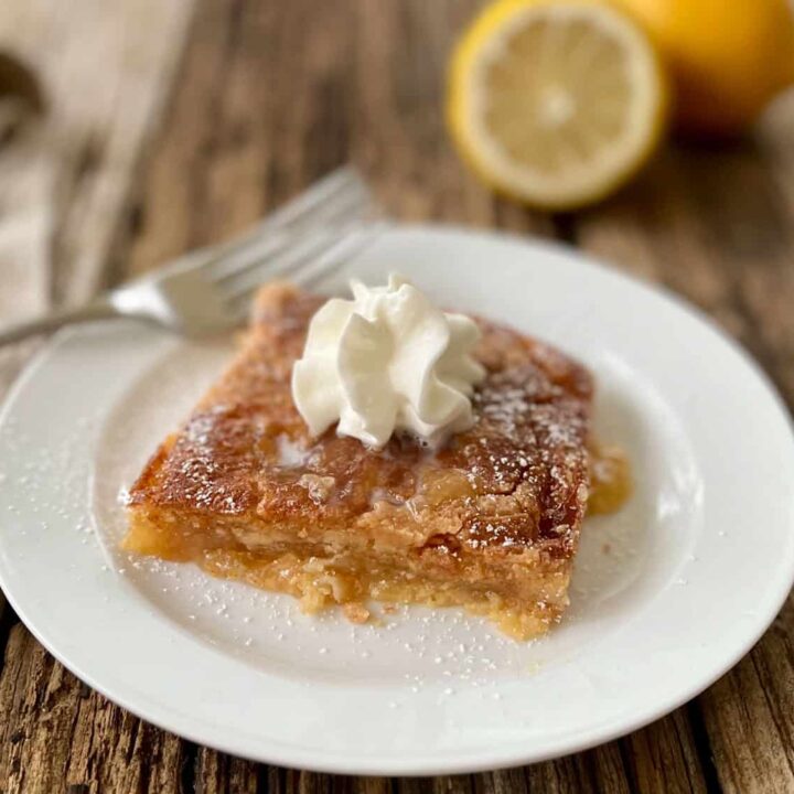 Lemon Dump Cake on a plate with a fork.