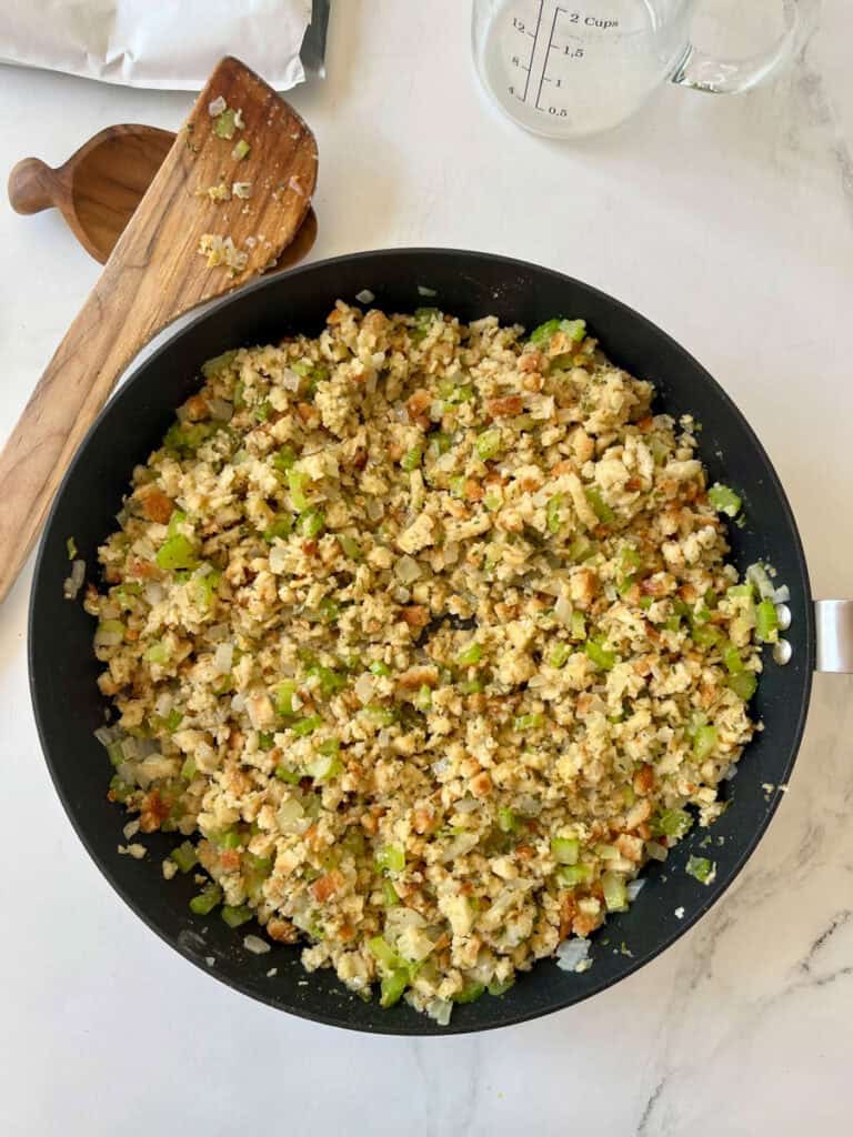 A pan filled with stuffing mixture on a table.