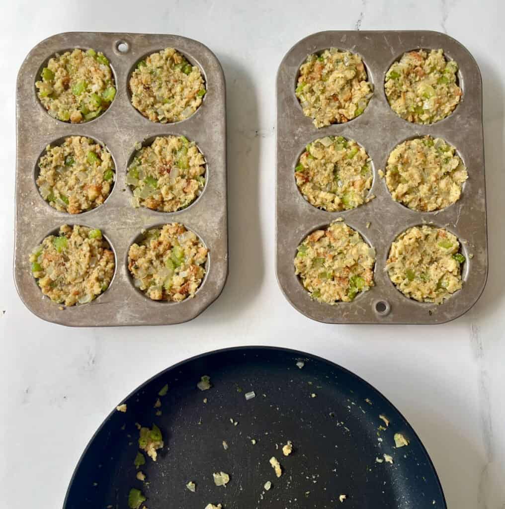 Two muffin pans filled with unbaked stuffing and an empty pan.