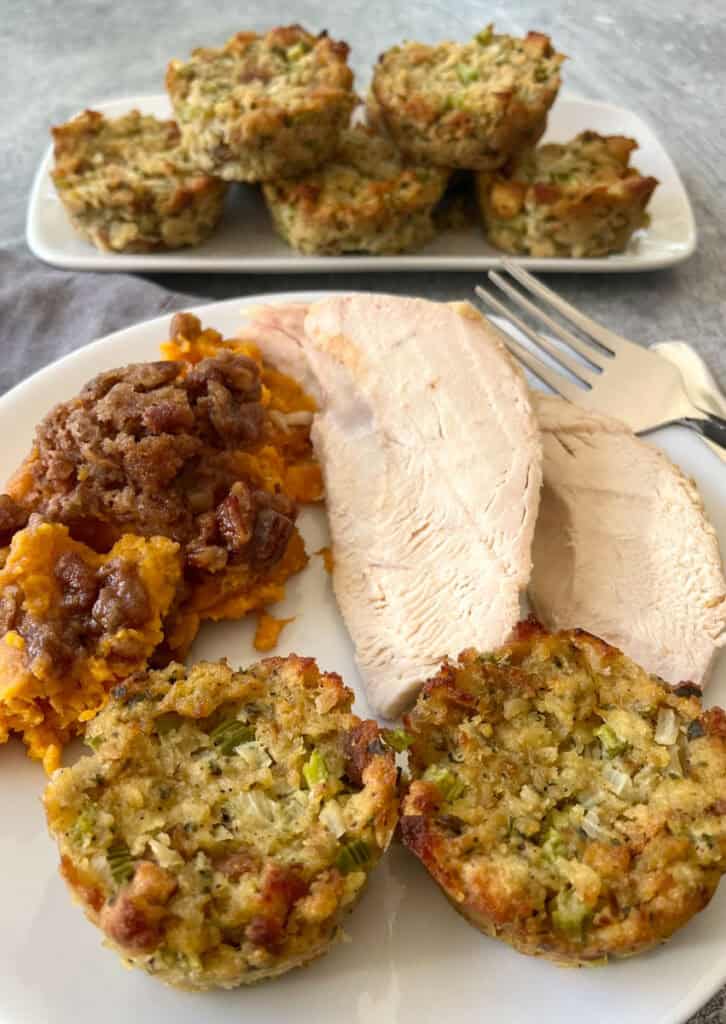 A plate of turkey, stuffing and sweet potato casserole.