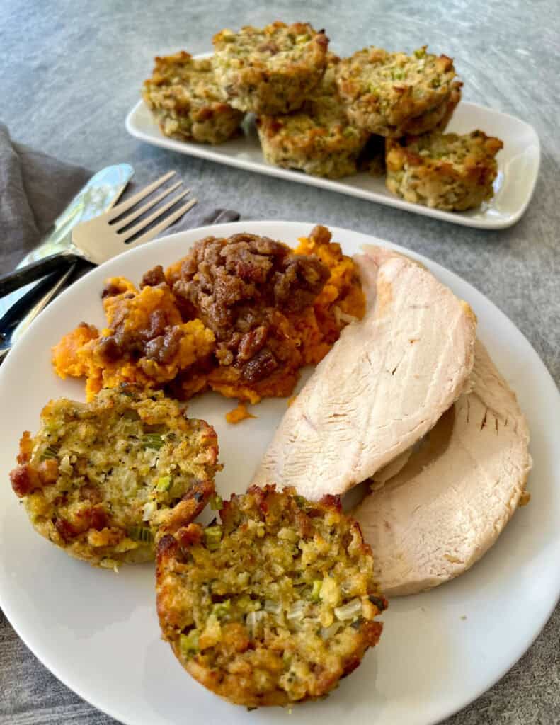 A plate of turkey, stuffing and sweet potato casserole.