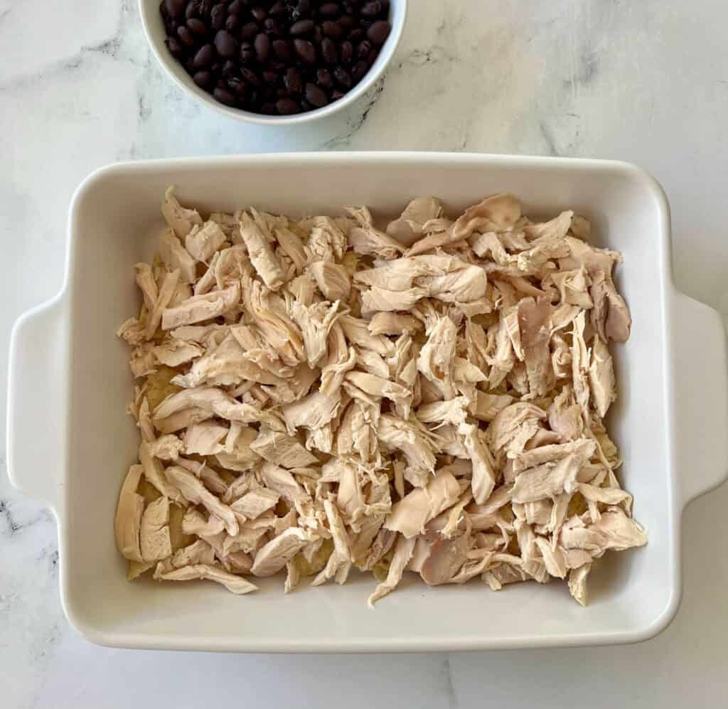 Shredded chicken in a baking dish.