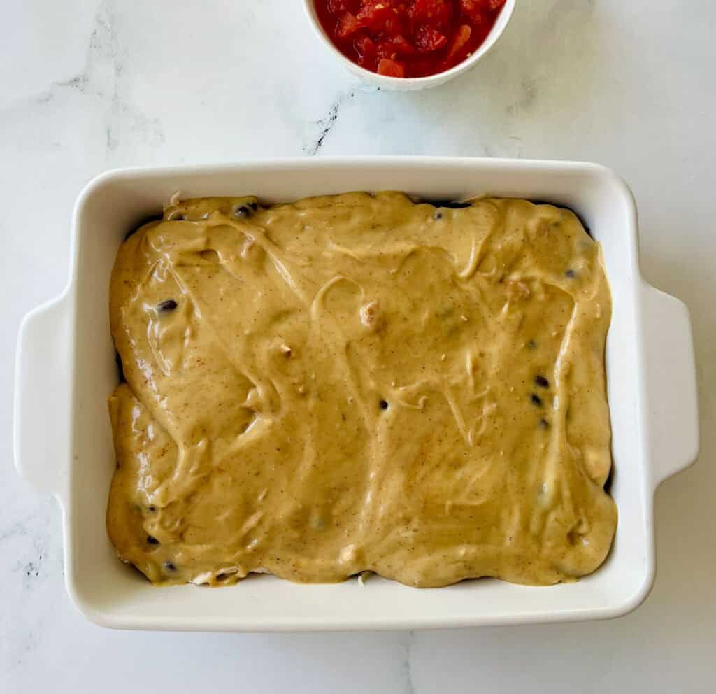 Mexican chicken casserole in a white baking dish.