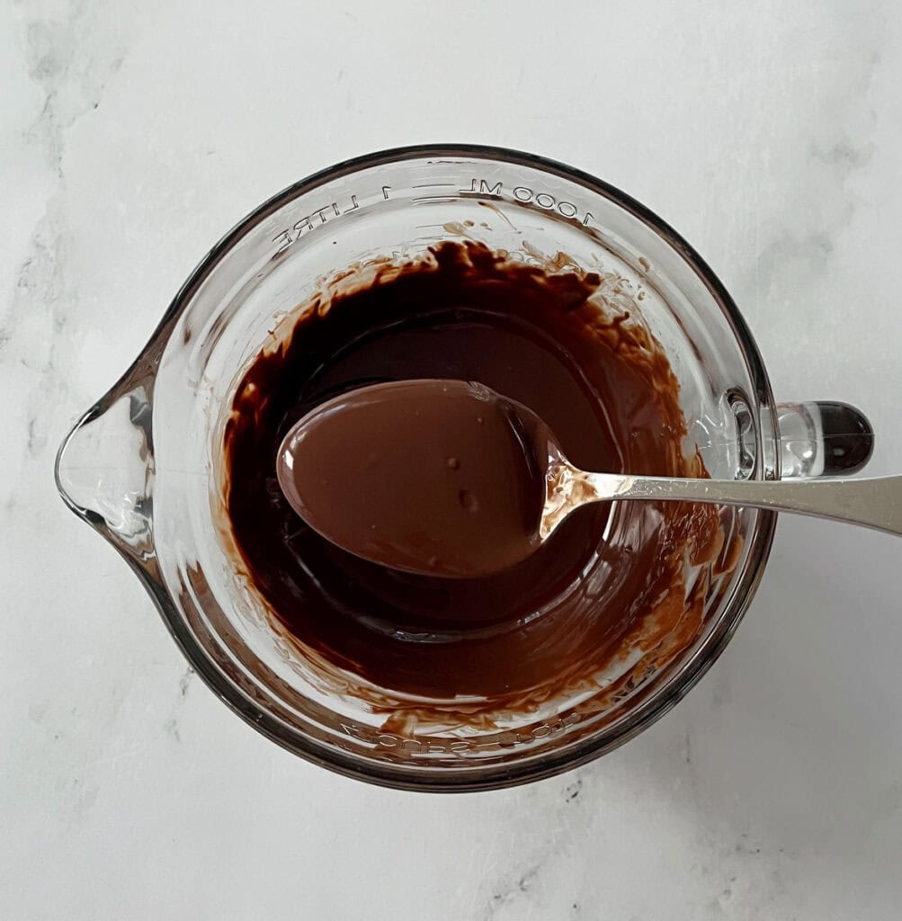 Chocolate melted in a glass bowl.