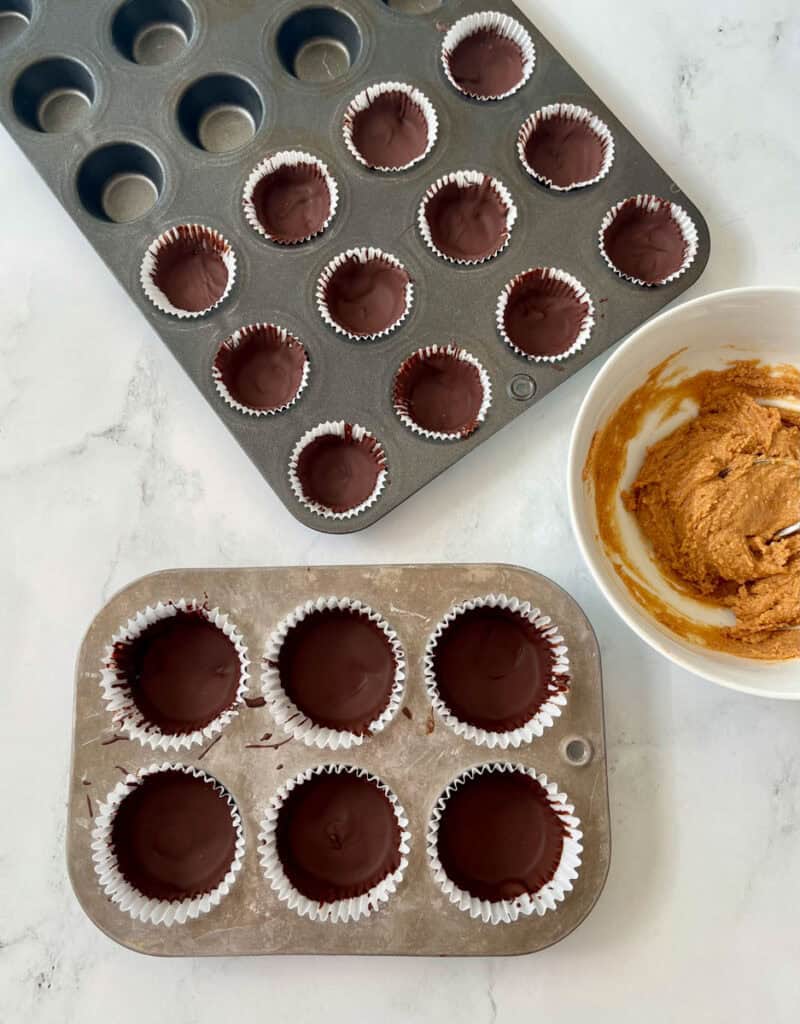 Chocolate peanut butter cups in a muffin tin.
