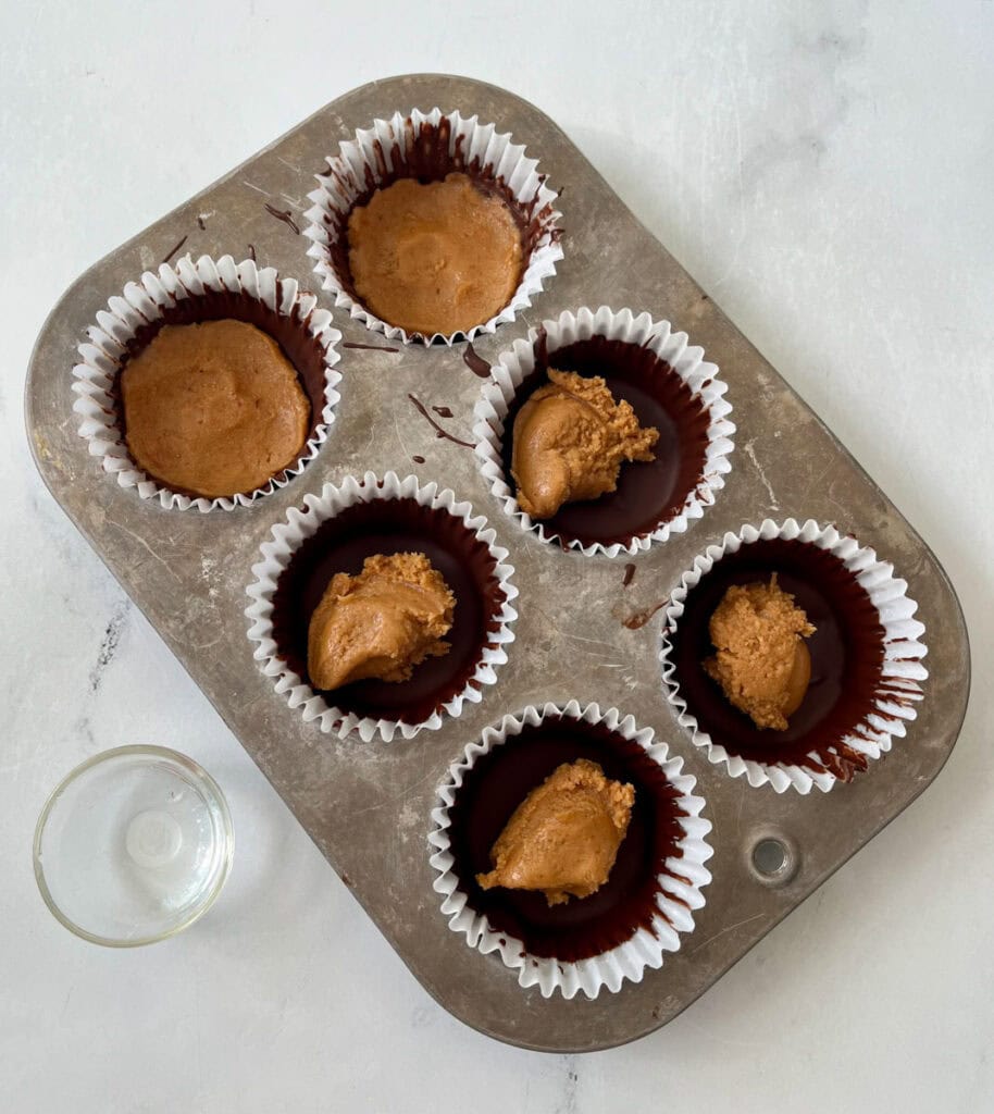 Peanut butter cups in a muffin tin.
