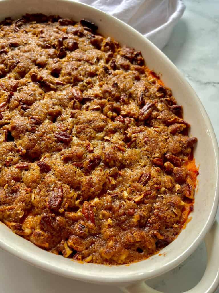 Sweet potato casserole in a white casserole dish.