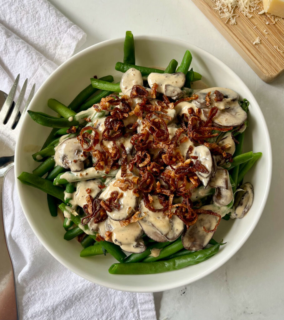 Green bean and mushroom a with creamy sauce and crispy shallots.