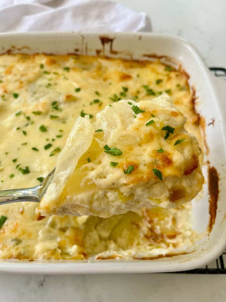 Cheesy potato casserole in a baking dish.