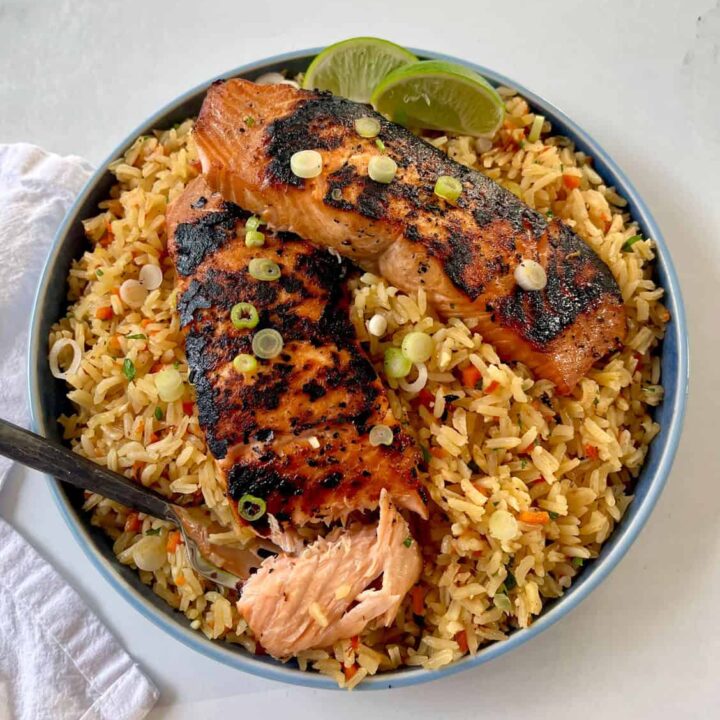 Grilled salmon and rice in a bowl.