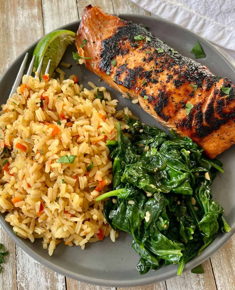 Grilled salmon with rice and spinach.