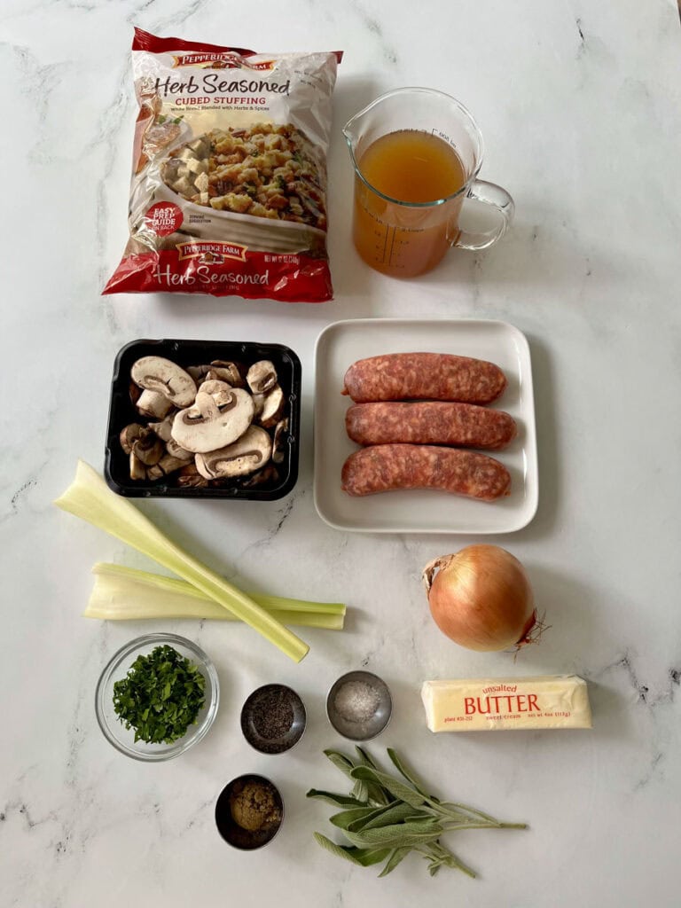 Ingredients for stuffing with sausage on a marble surface.