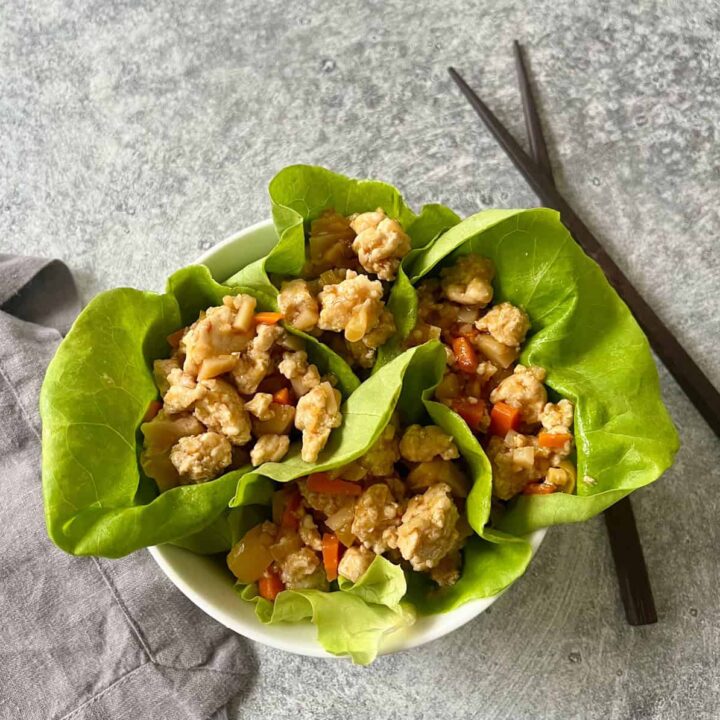 Stir-fried chicken with vegetables served in lettuce cups.