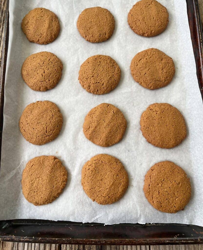 Soft baked cookies fresh on a parchment paper lined baking sheet.