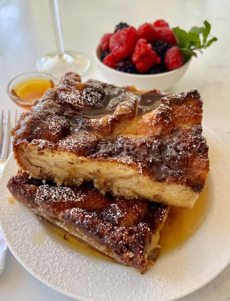 French toast casserole with berries and syrup, perfect for breakfast or brunch.