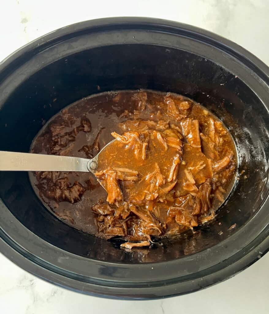 Slow cooker beef with tender shredded meat and rich gravy.