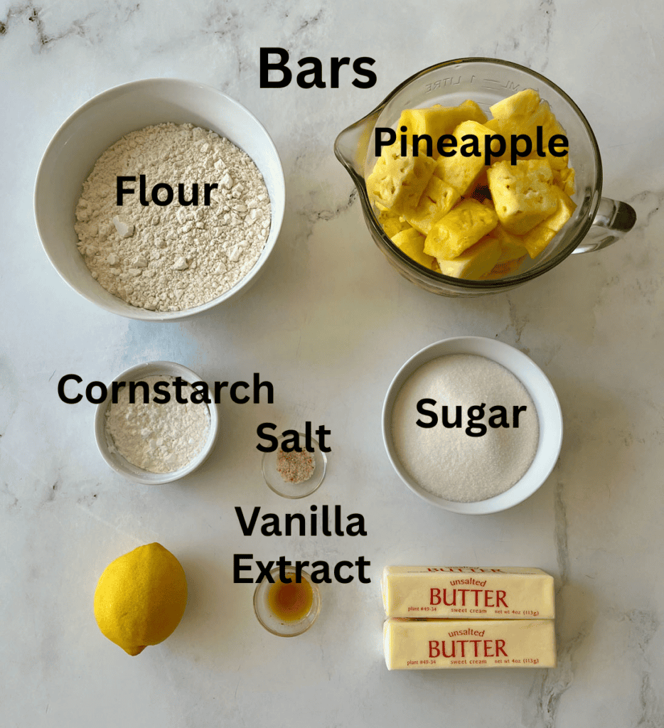 ingredients needed to make pineapple bars, including flour, sugar, butter, lemon, vanilla extract, salt, cornstarch, and fresh pineapple chunks.