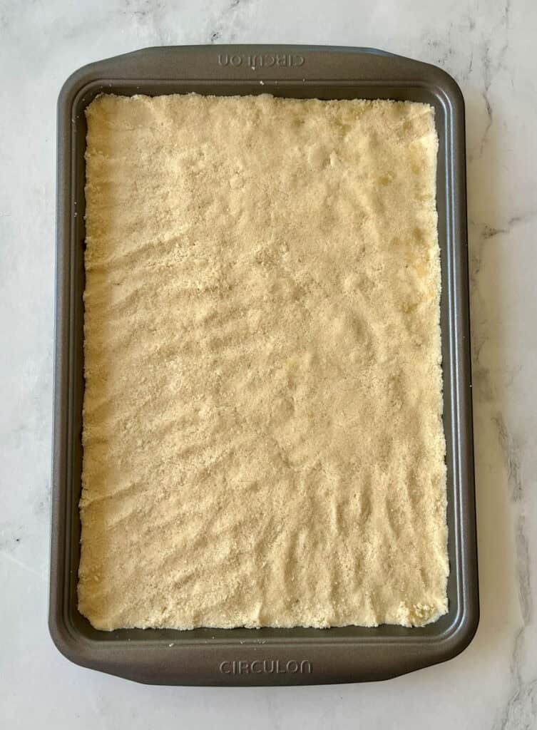 Dessert crust ready for baking in a rectangular dish.