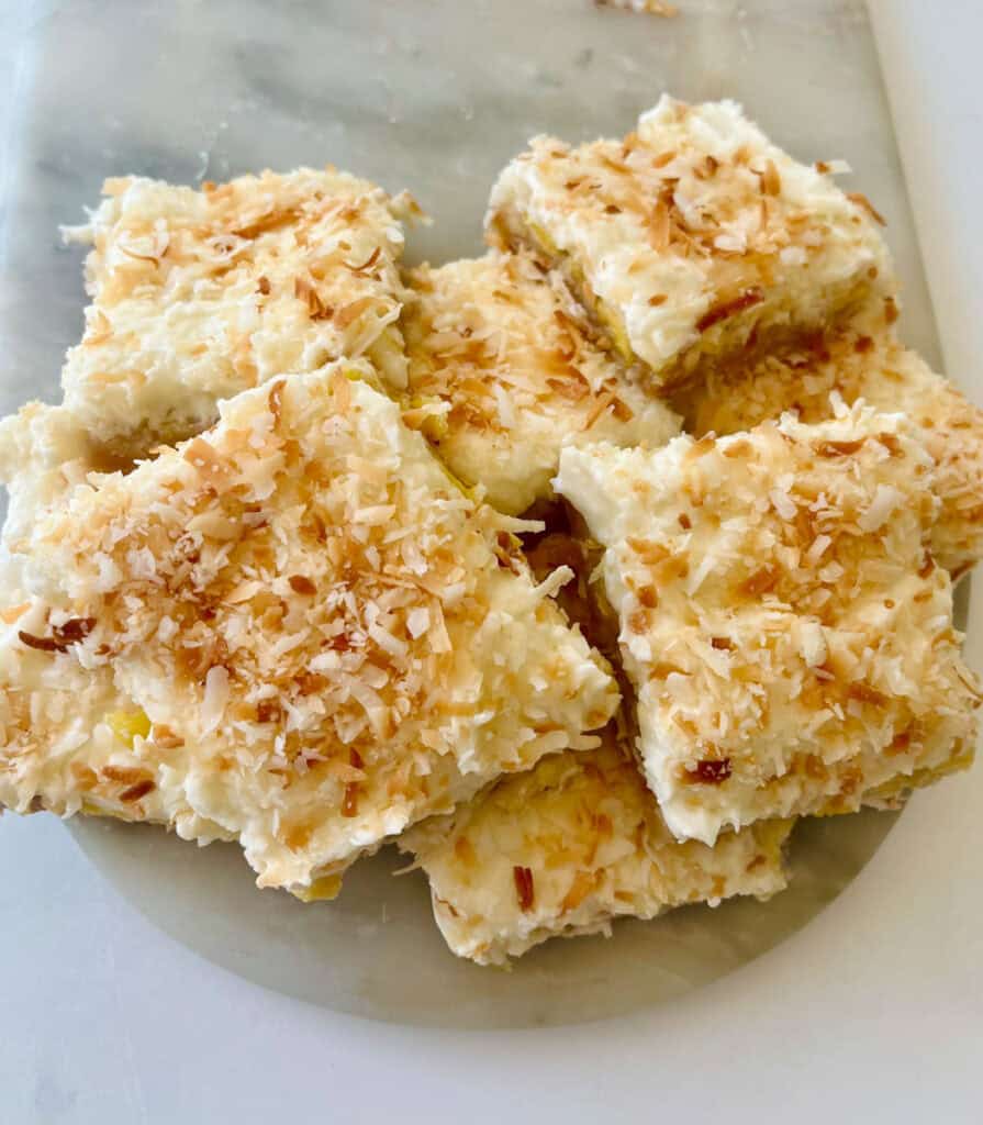 Coconut dessert bars with toasted coconut topping, perfect for snacks or desserts.