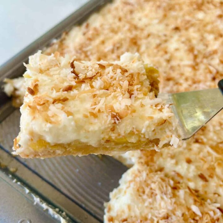 Pineapple bars with toasted coconut topping in a baking dish.
