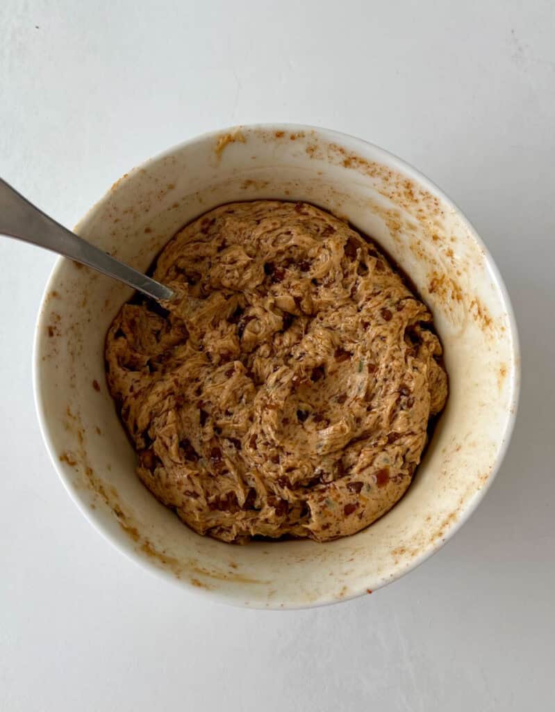 Butter mixture in a white bowl with a spoon.