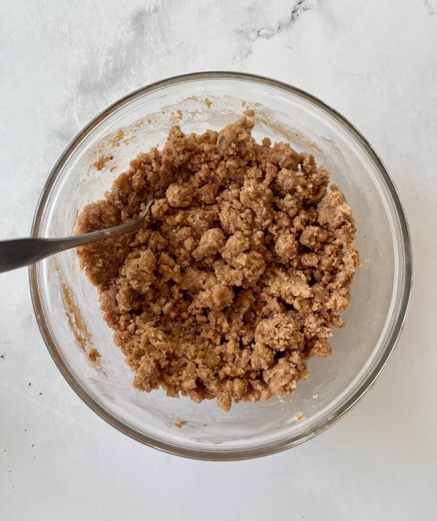 Cinnamon streusel topping in glass bowl for baking or snacking.