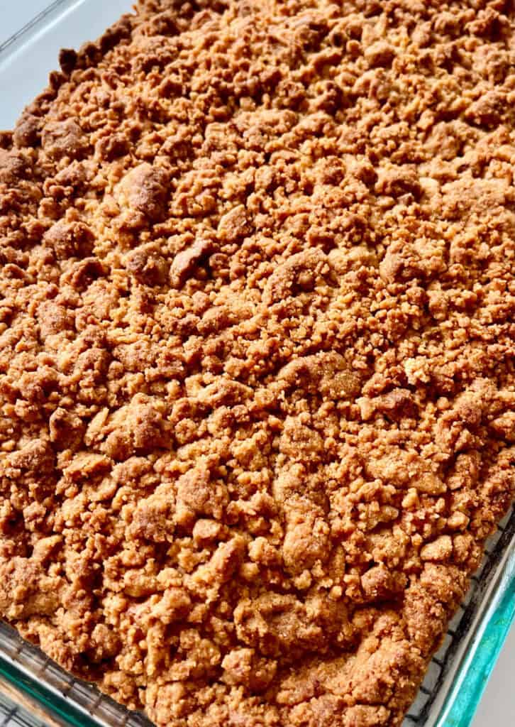 Close-up of a baked coffee cake with a crumbly topping.